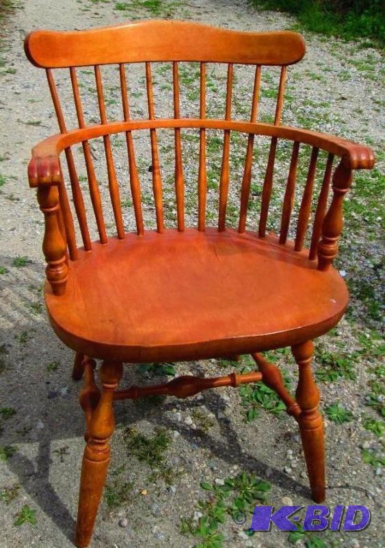 small wooden chair with decorative legs and a...