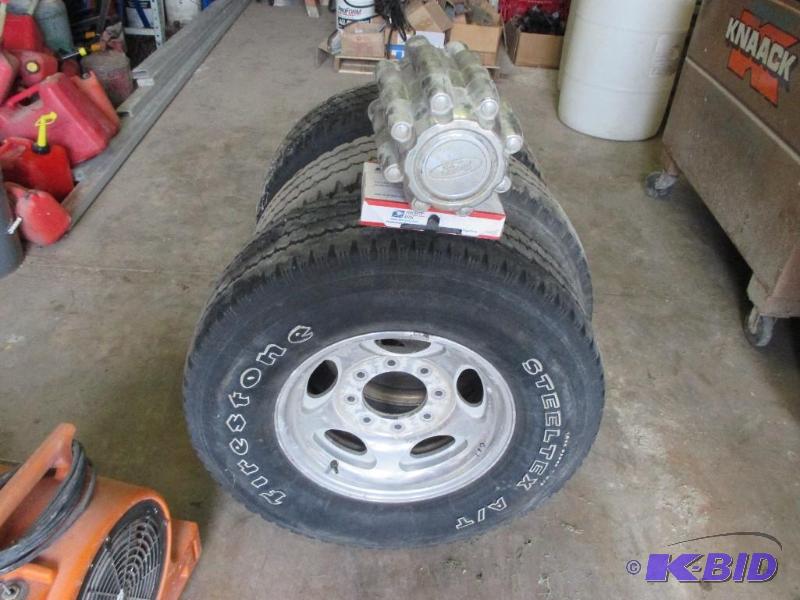 lot 102 image: Set of 4 rims and tires off 2000s Ford F350...