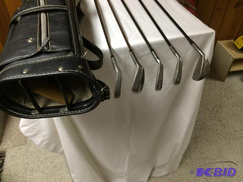 Older antique golf bag with 5 irons