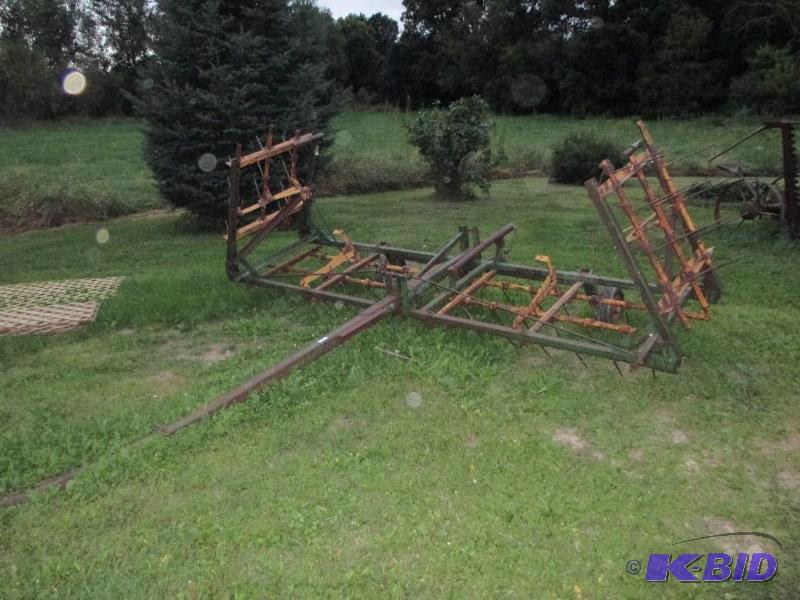 Tow behind spring tooth drag with fold down s...