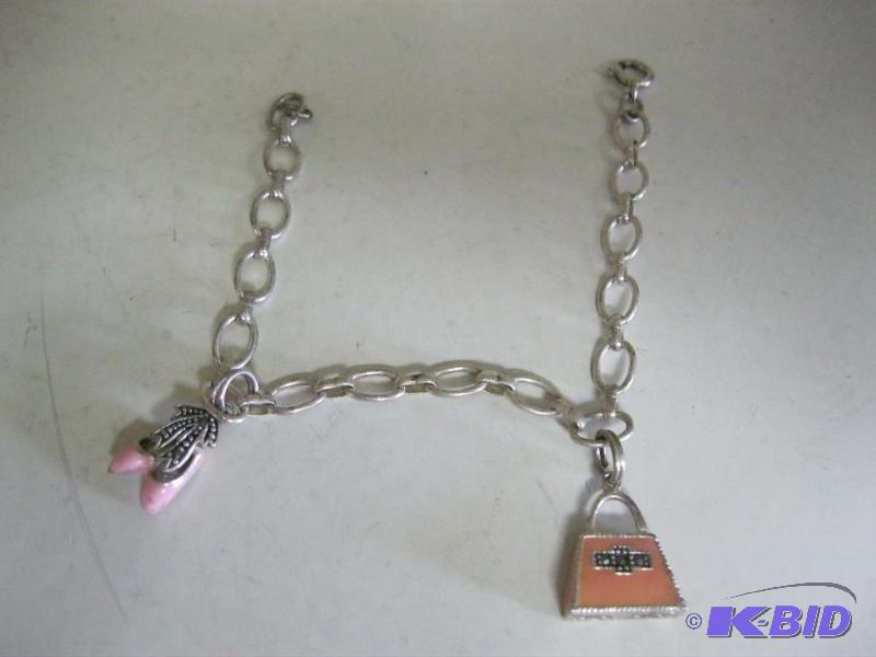 lot 81 image: Pair Of Charms On A Braclet...