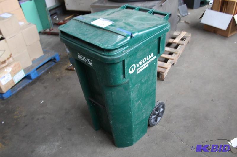 lot 176 image: Plastic garbage bin green. Includes contents...