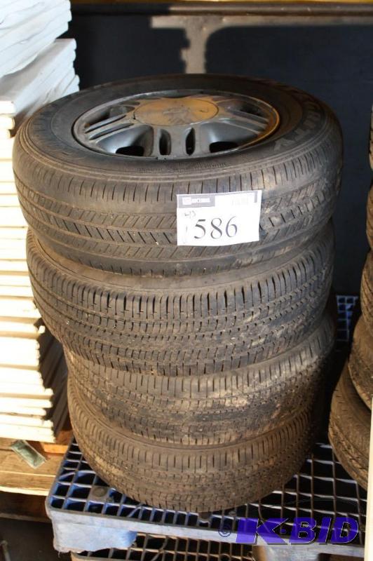 lot 586 image: Lot of (4) Integrity tires with hubcapsrims....