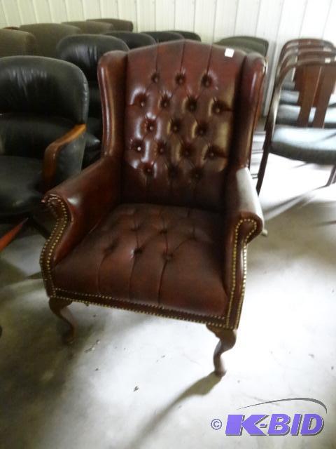 Wood framed leather chair. Small knick in the...