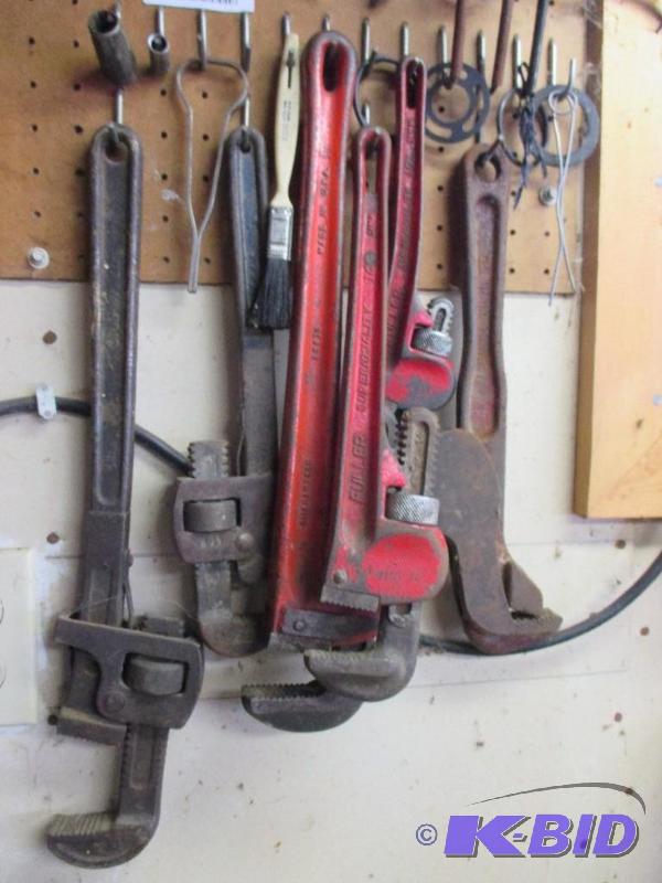 pipe wrenches and wrenches on pegboard...