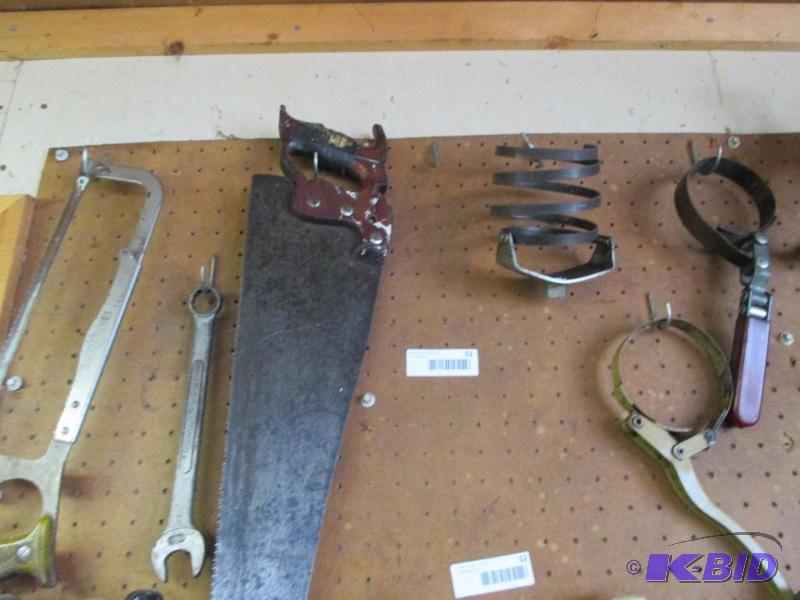saws and oil filter wrenches on pegboard...