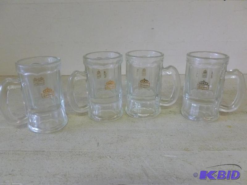 lot 103 image: A set of four Corona glass beer mugs that mea...