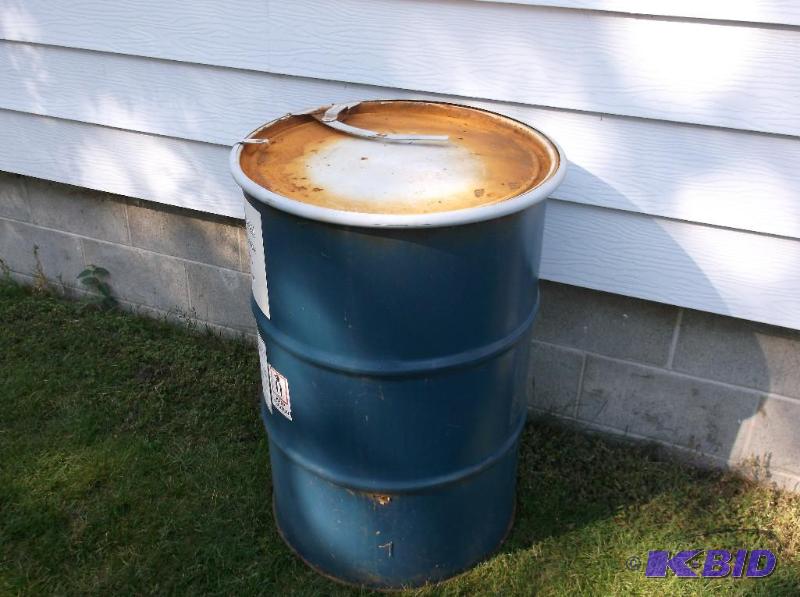 lot 42 image: Food grade 55 gallon metal barrel with lid &a...