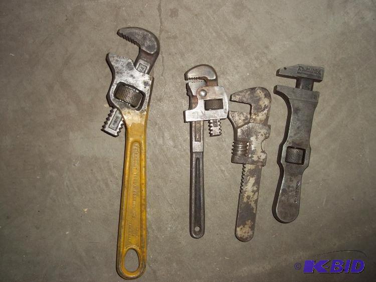 3 small pipe wrenches and on side pipe wrench...