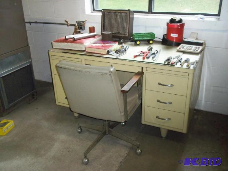 Metal desk with rolling chair, contents not i...