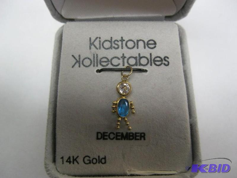 lot 39 image: Small 14k December kid charm....
