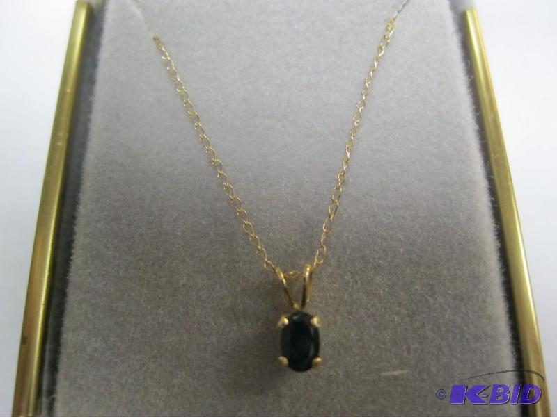 lot 44 image: 14k necklace and dark blue stone....