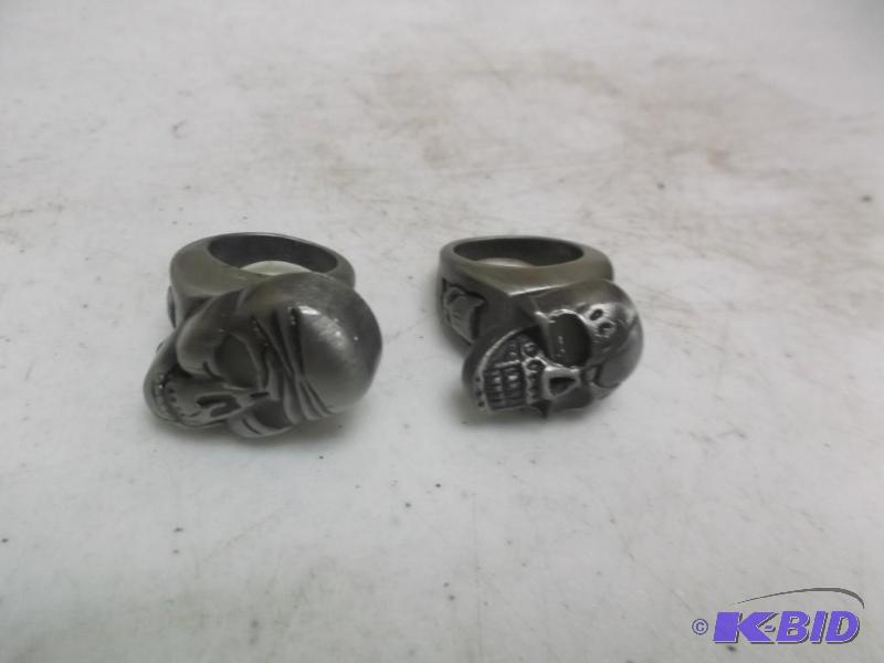 lot 48 image: Pair of metal light up skull rings....