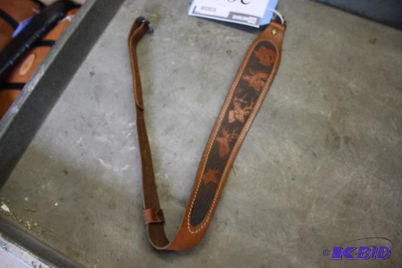 lot 205 image: Lot of (1) Leather rifle strap with deer impr...