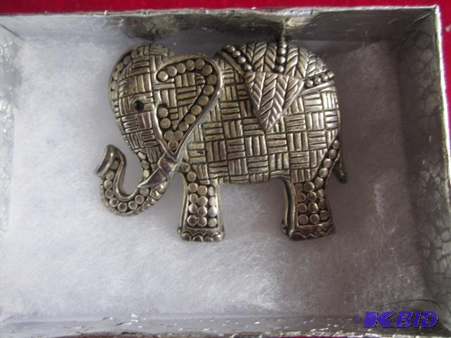 Silver tone elephant brooch with stone eye.&n...