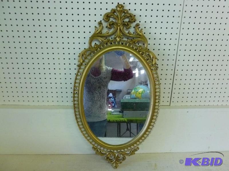 lot 27 image: Large decorative oval hall mirror that measur...
