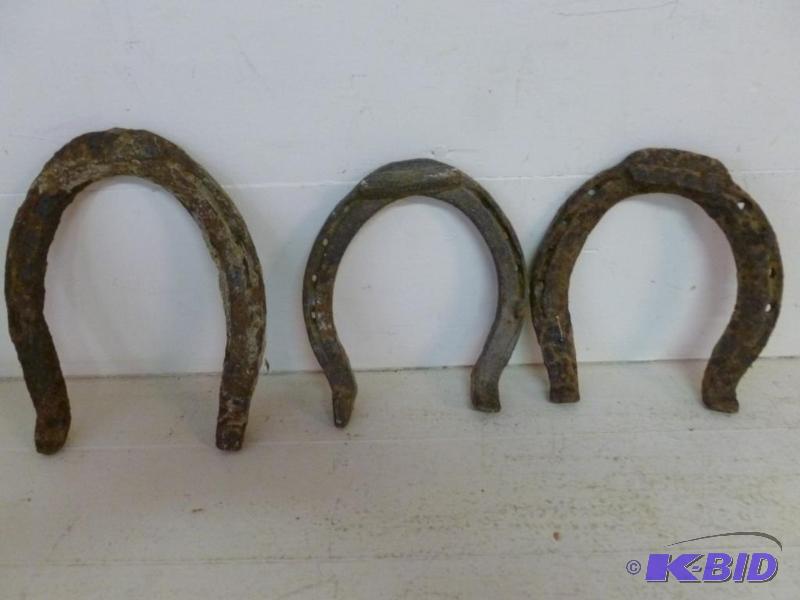 lot 79 image: Lot of three large antique iron horse shoes, ...