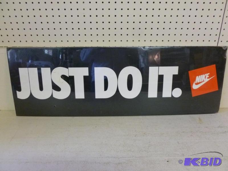lot 98 image: Nike - Just Do It poster on protective board ...