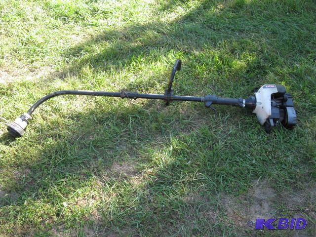 Gas powered trimmer, has compression, running...