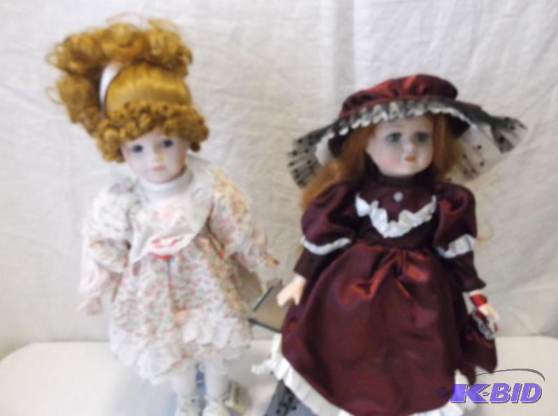 Collectable porcelain dolls on stands appear ...
