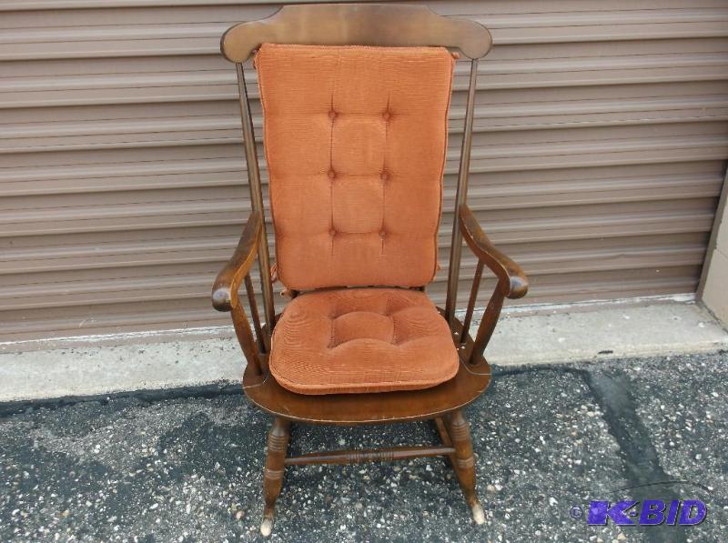Solid wood rocking chair with cushion has som...