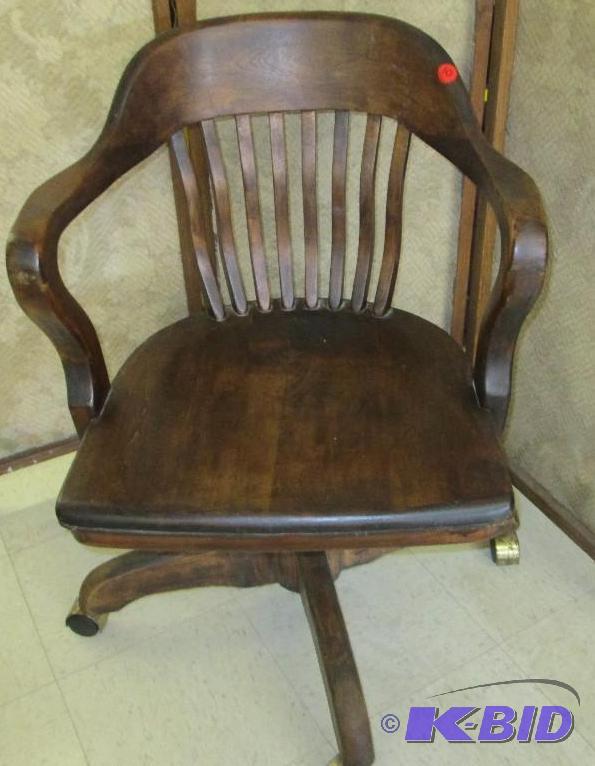 lot 10 image: Antique desk swivel chair on wheels...
