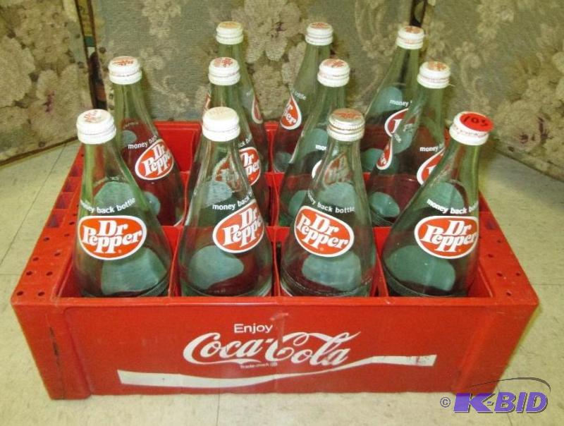 lot 103 image: Dr Pepper bottles in vintage Coca cola case...