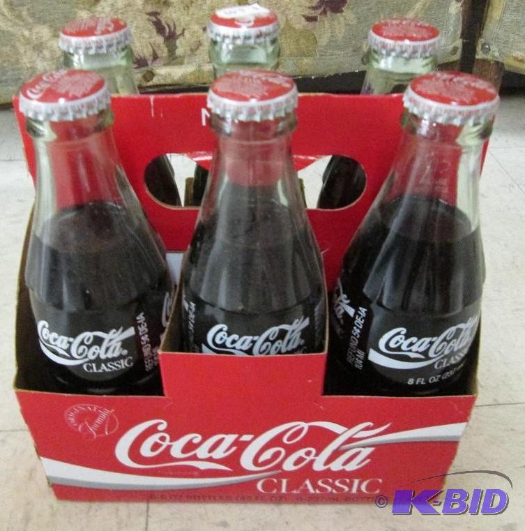 lot 104 image: Coca Cola bottles, unopened...