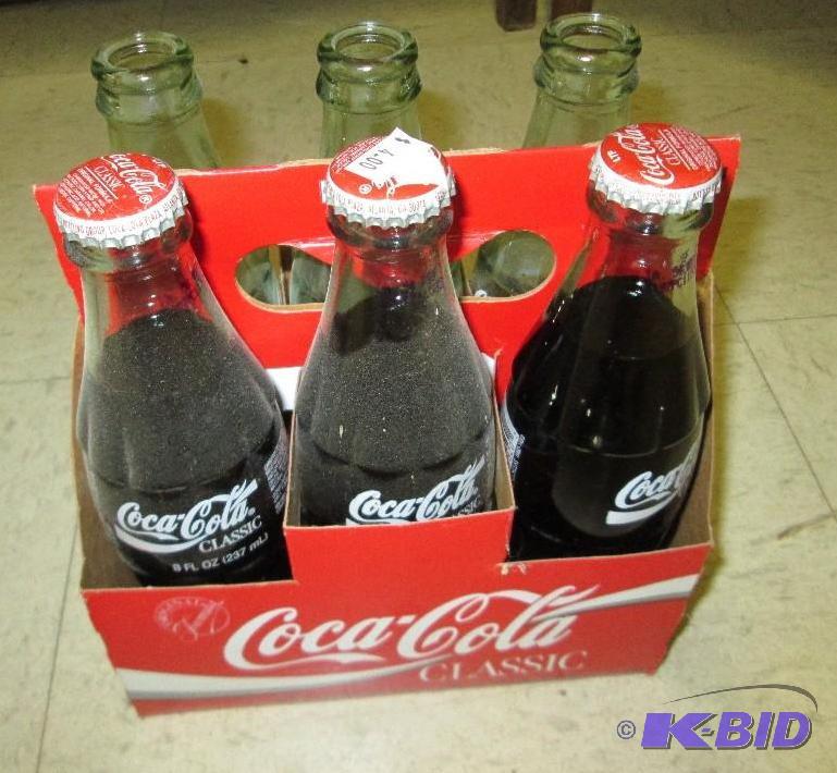 lot 105 image: Coca Cola bottles, unopened 3 and 3 open...