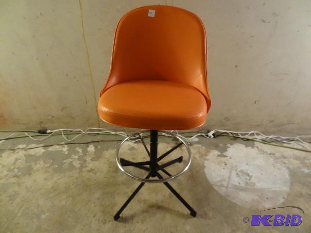 Adjustable bar stool. Bright orange vinyl sea...
