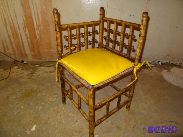 Antique bamboo chair with bold vinyl cushion....