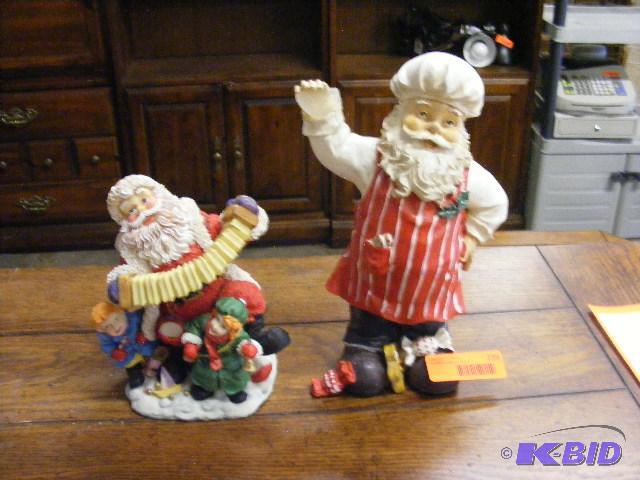two Santa figurines. the chef santa was holdi...