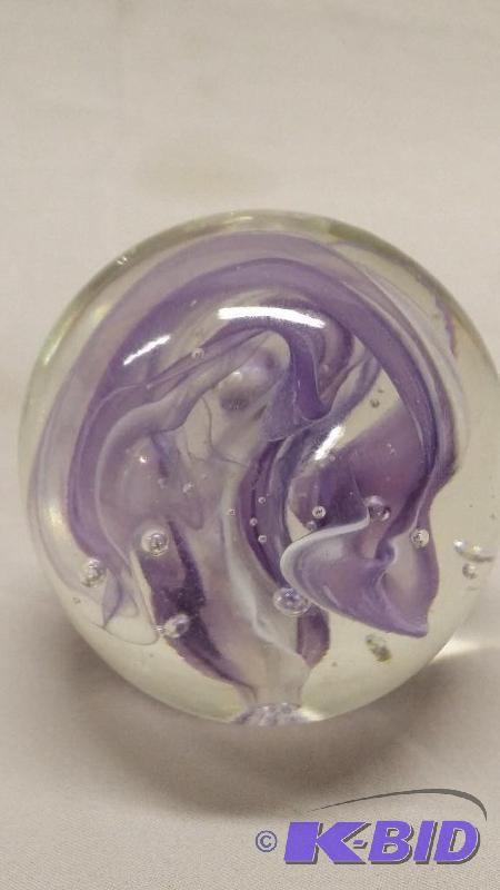 Blown glass paper weight with purple swirls. ...