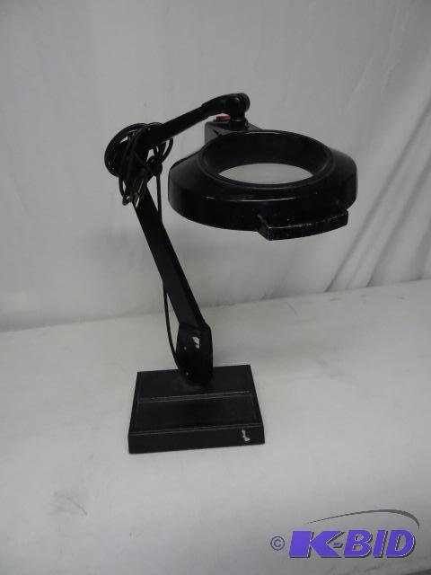 lot 18 image: Magnifying light with weighted base...