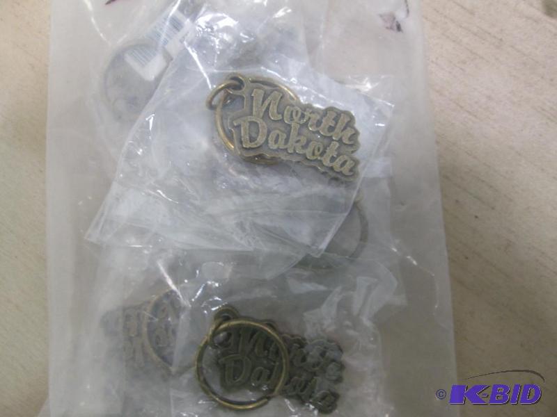 Qty 12 metal key chains that says North Dakot...