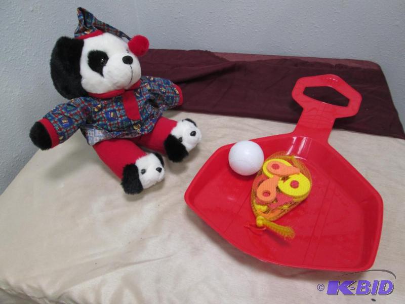 A big plastic shovel and a teddy bear...