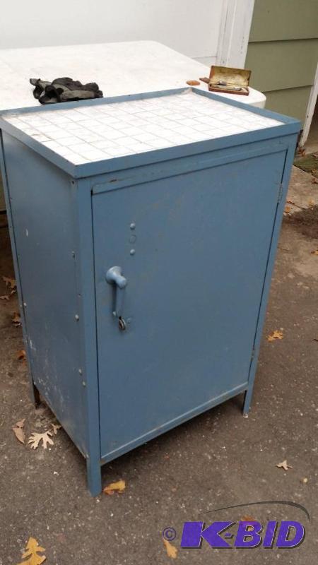 Blue metal cabinet wwhite tile top. Measures...