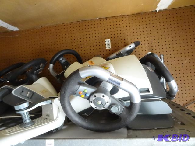 lot 100 image: Several X Box 360 wireless racing wheels and ...