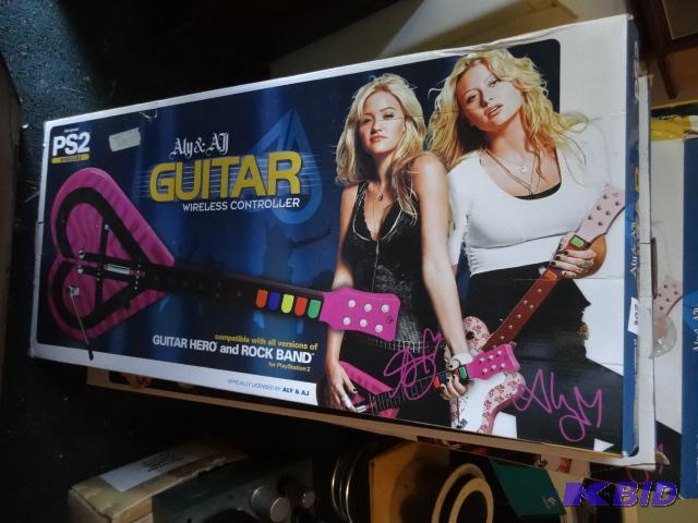 lot 208 image: 5 PS2 wireless ALY and Ali guitar controllers...