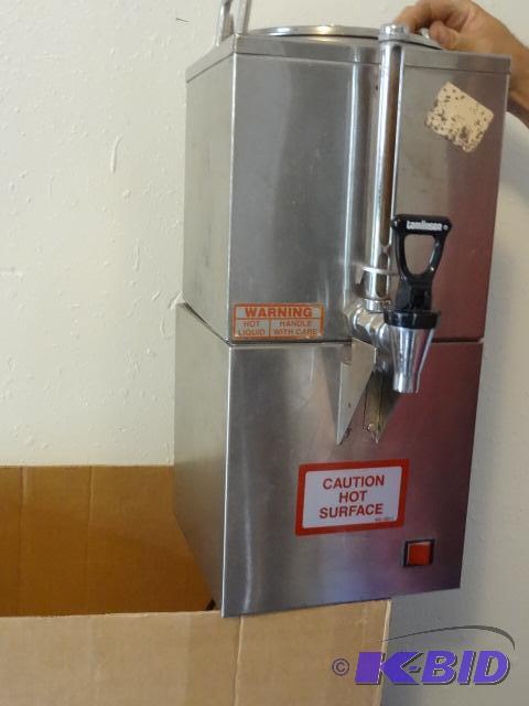 lot 228 image: Coffee dispenser with heater. 2 rubber flaps....