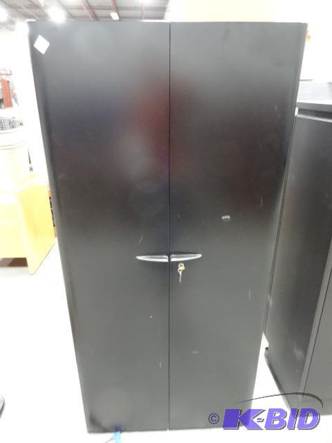 2 door metal cabinet. 3 shelves. Lock and Key...