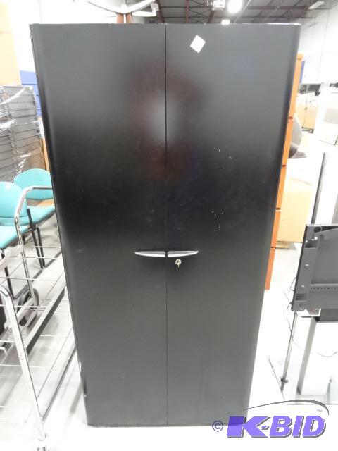 2 door metal cabinet. 3 shelves. Lock and Key...