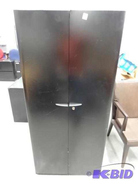 2 door metal cabinet. 3 shelves. Lock and Key...