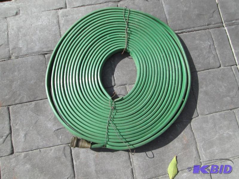 lot 13 image: Coiled garden hose, new or like new...