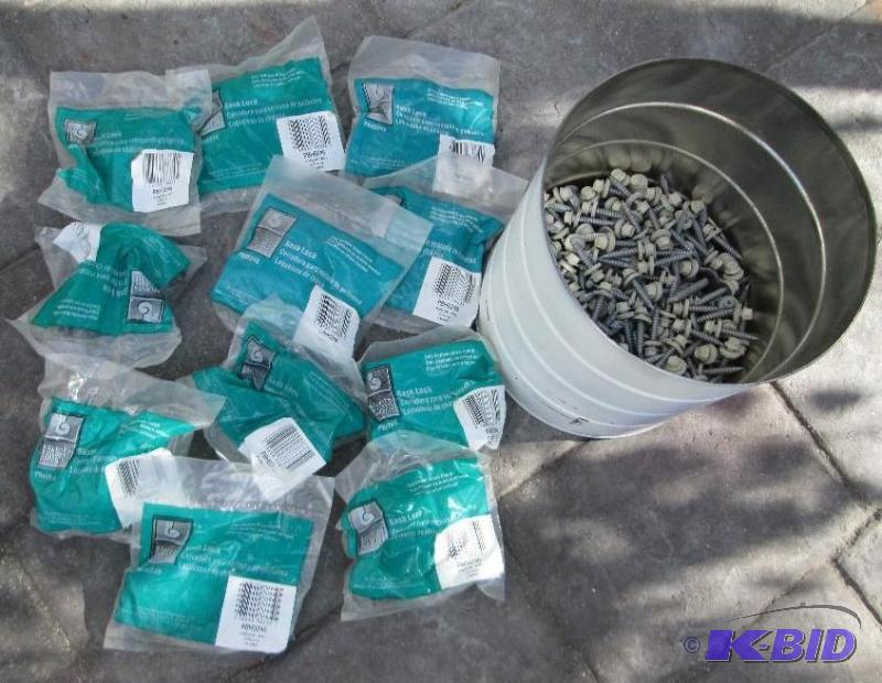 lot 27 image: Can of 1 inch rubber gasket steel fastners an...
