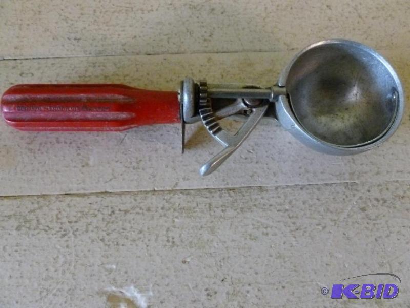 lot 29 image: Vintage red handled ice cream scoop....