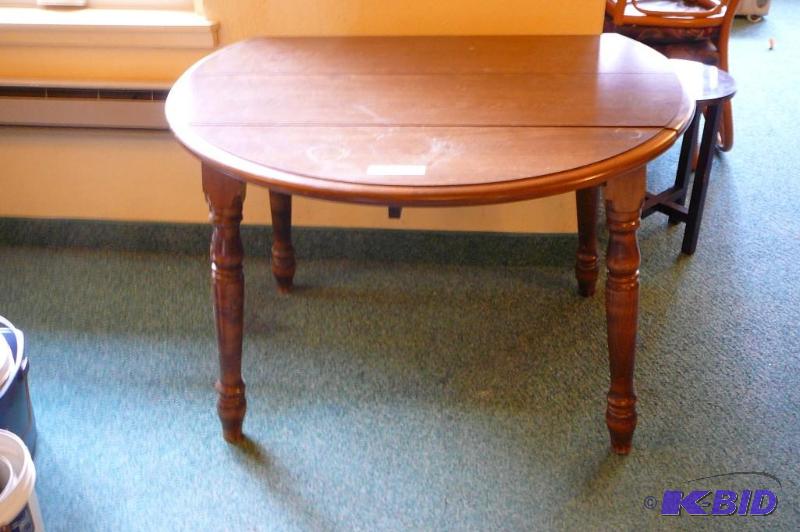 lot 57 image: 42" round wooden table with 2 drop leafs...