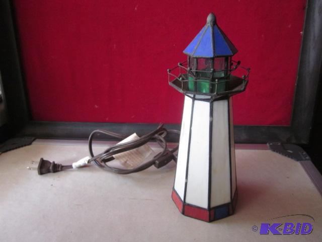 lot 28 image: 11 inch stainedleaded glass light house lamp...