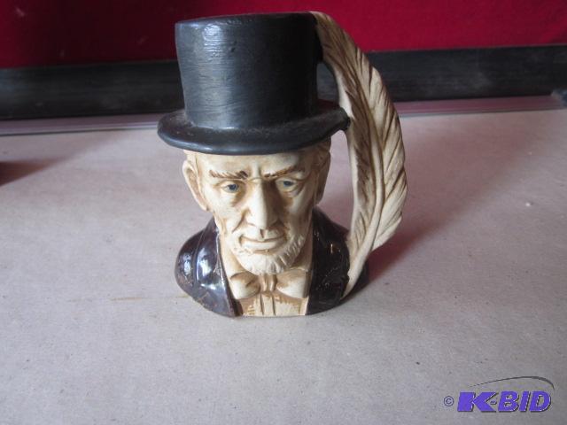 lot 35 image: Orange brown glazed Abraham Lincoln pottery b...