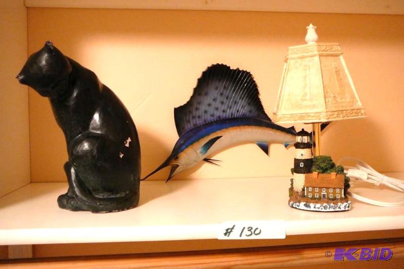 Blue marlin, cat figurine and a light house l...
